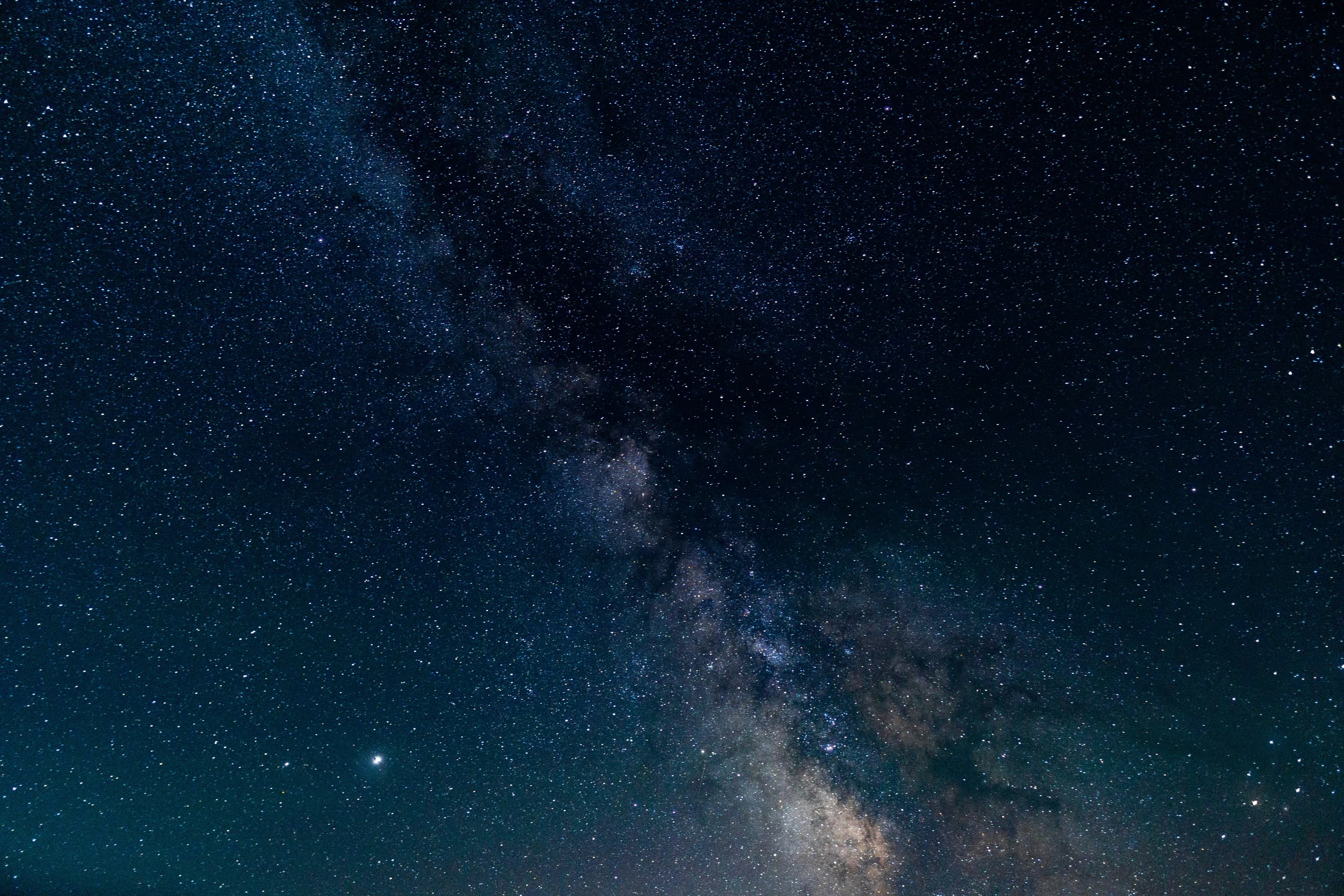 The Milky Way stretching across a dark night sky.
