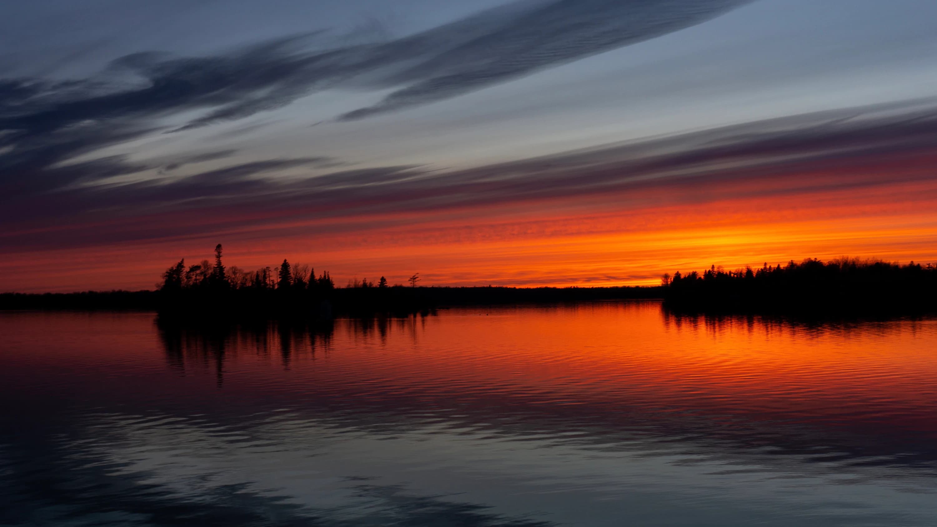 Clouds gathering above a colorful sunset.