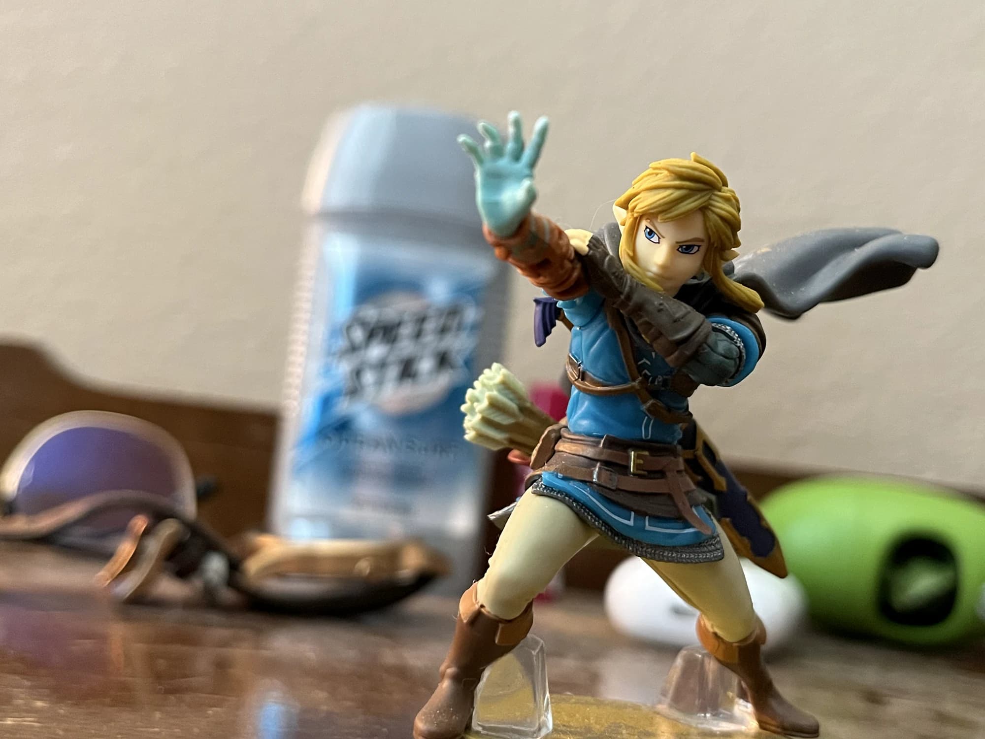 A Link figurine posed with one hand raised on a tabletop.